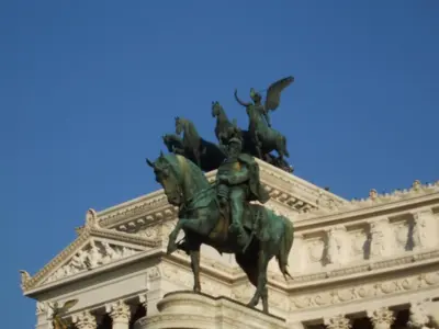 a statue of a man on a horse in front of a building at 2 Be Home Colosseo in Rome