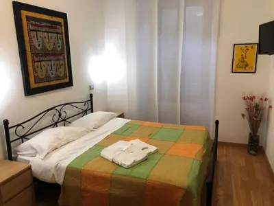 a bedroom with a bed with a colorful blanket at Maison Vaticana in Rome
