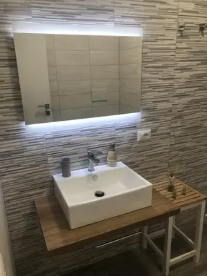 a white sink in a bathroom with a mirror at Maison Vaticana in Rome