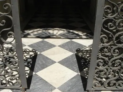a black and white checkered floor with a iron gate at Sweet Dreams Roma in Rome