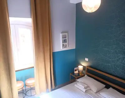 a bedroom with a bed and a blue wall at Sweet Dreams Roma in Rome