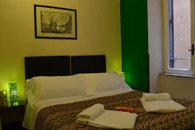 a bedroom with a bed with two towels on it at Enjoy Roma in Rome