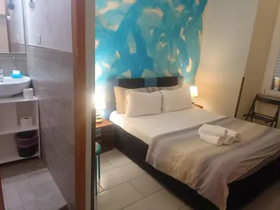 a small bedroom with a bed and a sink at Enjoy Roma in Rome