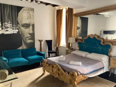 a bedroom with a king sized bed and a couch at D.R.Rome Spanish Luxury Suites in Rome