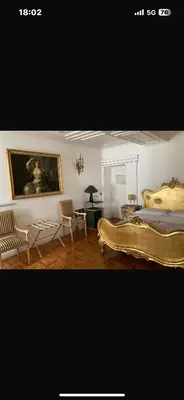 a bedroom with a bed and a table and chairs at D.R.Rome Spanish Luxury Suites in Rome