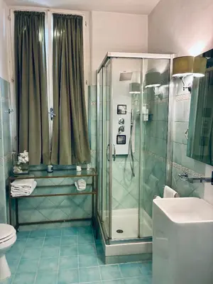 a bathroom with a shower and a toilet at D.R.Rome Spanish Luxury Suites in Rome