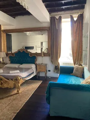 a bedroom with two beds and a window at D.R.Rome Spanish Luxury Suites in Rome