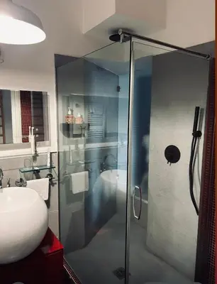 a bathroom with a glass shower and a sink at D.R.Rome Spanish Luxury Suites in Rome