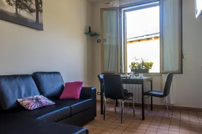 a living room with a couch and a table with chairs at San Pietro's Home in Rome
