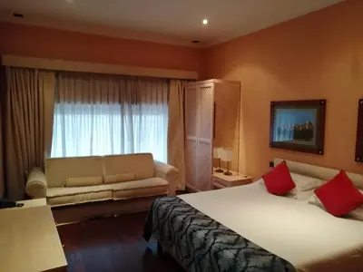 a hotel room with a bed and a couch at Colosseo Studio Suite in Rome