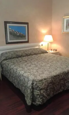 a bedroom with a bed in a hotel room at Colosseo Studio Suite in Rome