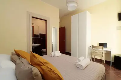 a bedroom with a bed with two pillows on it at Cardinal Vatican Inn in Rome