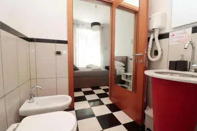 a small bathroom with a toilet and a sink at Cardinal Vatican Inn in Rome