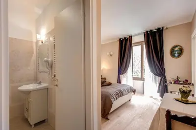 a bedroom with a bed and a sink and a window at La Reggia dei Principi in Rome
