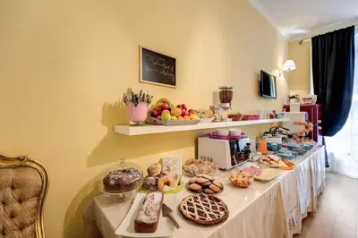 a table with many different types of pastries on it at La Reggia dei Principi in Rome