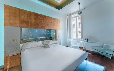 a bedroom with a large bed with an aquarium above it at Hotel Trecento in Rome