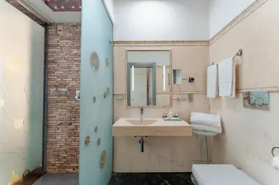 a bathroom with a sink and a mirror at Hotel Trecento in Rome