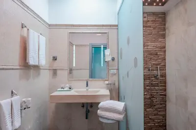 a bathroom with a sink and a mirror at Hotel Trecento in Rome