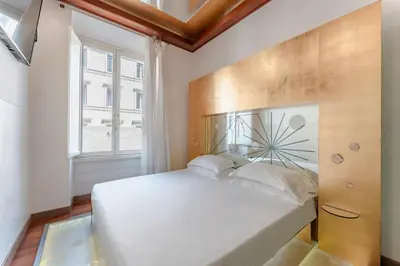 a bedroom with a large white bed and a window at Hotel Trecento in Rome