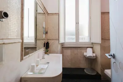 a bathroom with a sink and a mirror at Hotel Trecento in Rome