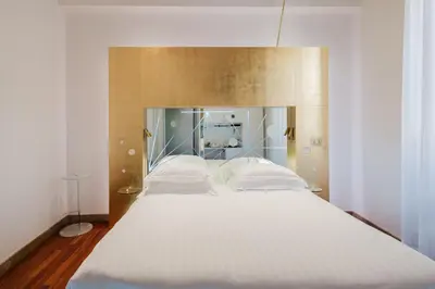 a large bed with white sheets and pillows at Hotel Trecento in Rome