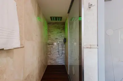 a bathroom with a walk in shower next to a walk in shower at Hotel Trecento in Rome