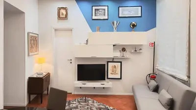 a living room with a couch and a television at Domus Chiara al Colosseo in Rome