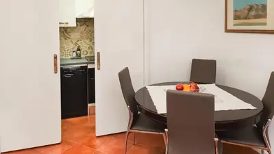 a dining room with a table and chairs at Domus Chiara al Colosseo in Rome
