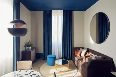 a living room with a couch and a table at Palazzo Velabro, a Member of Design Hotels in Rome