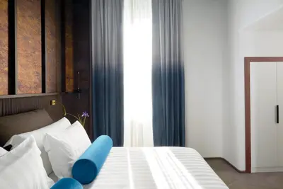 a bedroom with a bed with a blue object on it at Palazzo Velabro, a Member of Design Hotels in Rome