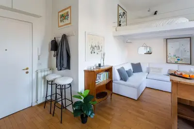a living room with a white couch and a table at Cozy Suite Pigneto in Rome