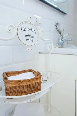 a bathroom with a basket sitting on a sink at Cozy Suite Pigneto in Rome