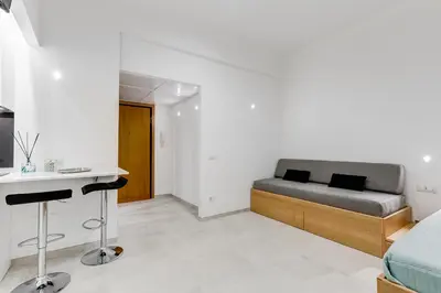 a bedroom with a bed and a desk in it at Vatican 96 Degli Ubaldi Charming Suite with terrace in Rome