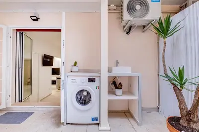 a washer and dryer in a room at Vatican 96 Degli Ubaldi Charming Suite with terrace in Rome