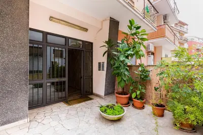 an entrance to a building with potted plants at Vatican 96 Degli Ubaldi Charming Suite with terrace in Rome