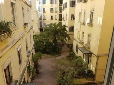a view of an alley between buildings with palm trees at Popolo square deluxe flat in Rome