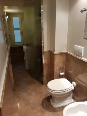 a bathroom with a toilet and a sink and a shower at Popolo square deluxe flat in Rome