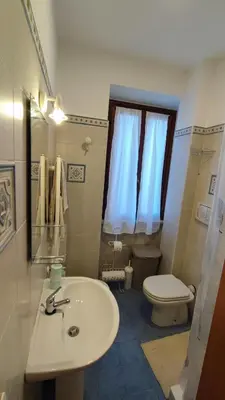 a bathroom with a white sink and a toilet at CASETTE DEI QUINTILI in Rome