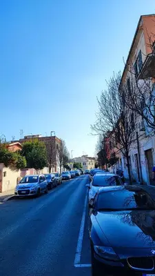 a row of parked cars on a city street at CASETTE DEI QUINTILI in Rome
