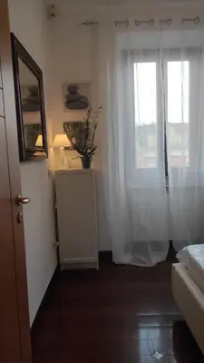 a room with a window with white curtains and a dresser at CASETTE DEI QUINTILI in Rome