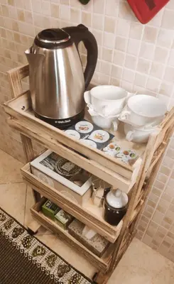 a tea kettle and other items on a wooden shelf at CASETTE DEI QUINTILI in Rome