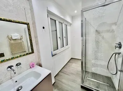 a bathroom with a shower and a sink and a mirror at Lussuoso 130 MQ zona Cipro in Rome