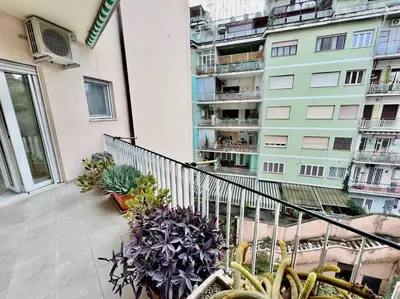 a balcony with potted plants and a building at Lussuoso 130 MQ zona Cipro in Rome