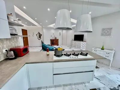 a kitchen with white counters and a stove top oven at Lussuoso 130 MQ zona Cipro in Rome
