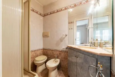 a bathroom with a toilet and a sink at GuestHost - MM Cipro Elegant Apartment in Rome