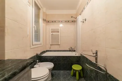 a bathroom with a tub and a toilet and a sink at GuestHost - MM Cipro Elegant Apartment in Rome