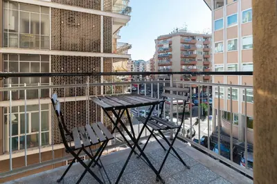 a table and two chairs on a balcony at GuestHost - MM Cipro Elegant Apartment in Rome