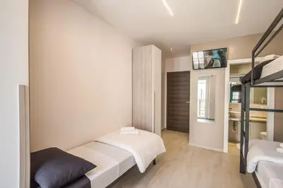 a bedroom with two beds and a bunk bed at Aurelia Vatican Suites in Rome