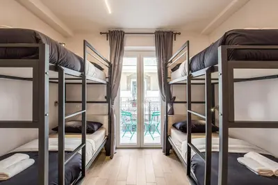 a room with four bunk beds and a patio at Aurelia Vatican Suites in Rome