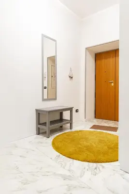 a living room with a table and a yellow rug at locazione turistica via dei savorelli 120 in Rome
